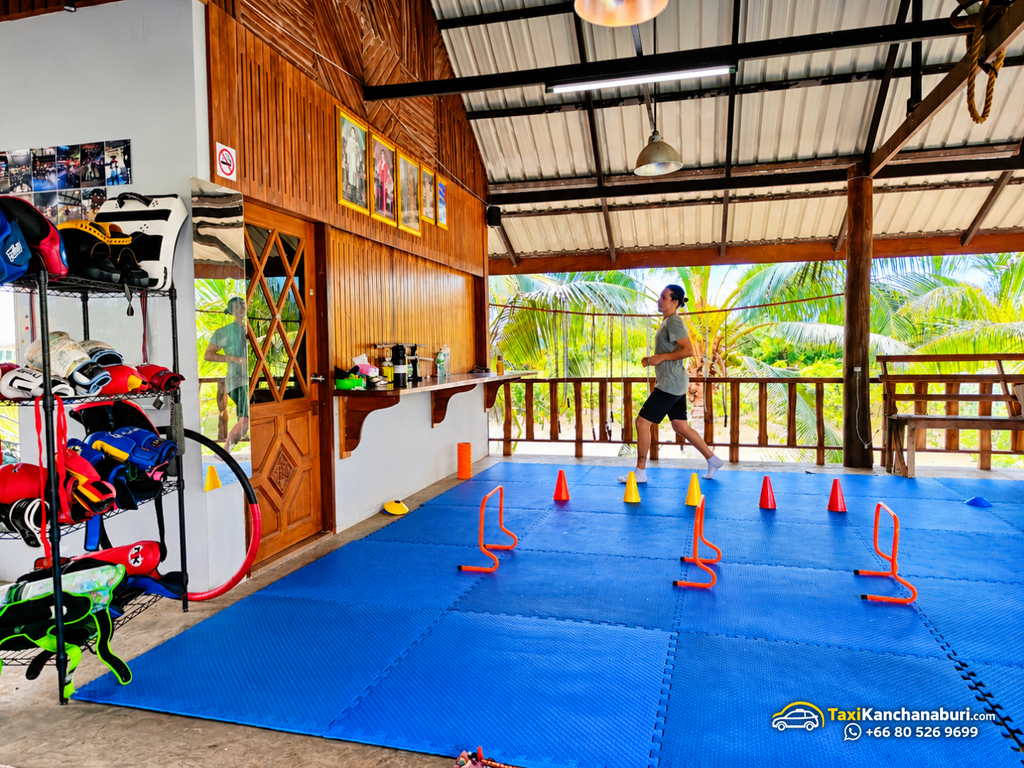 Muay Thai training area with blue mats and agility equipment at White Wolf Muay Thai Academy in Kanchanaburi